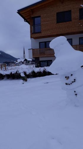 a pile of snow in front of a house at Neuner Charlotte Preise inclusive Sommercard in Wenns