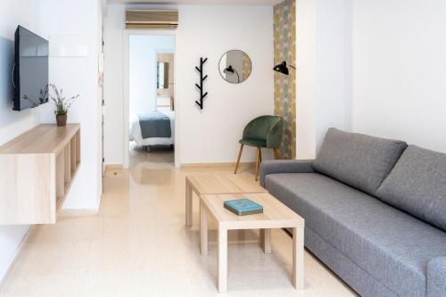a living room with a couch and a table at CALMA Apartments in Benidorm