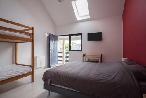 a bedroom with a bed and a television in it at Les chambres du Bistro du Canal in Pleyben