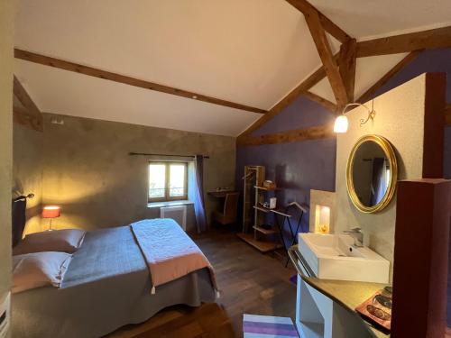 1 dormitorio con cama, lavabo y espejo en Domaine de Pipangaille, en Andancette