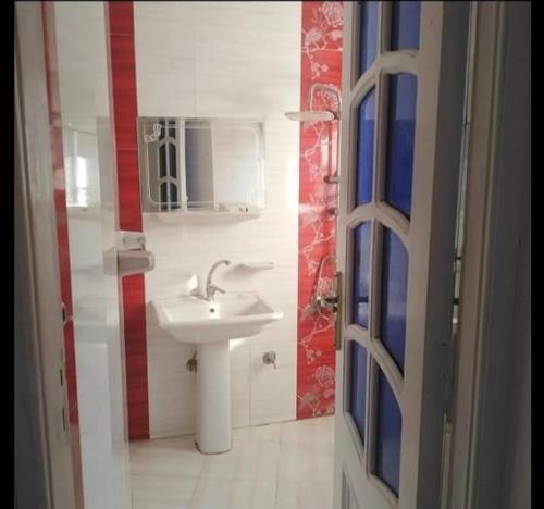 La salle de bains est pourvue d'un lavabo et d'un miroir. dans l'établissement دمياط الجديدة, à Dumyāţ al Jadīdah