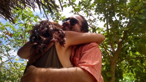 a man hugging a woman on a swing at EcoMar - Pousada de Experiência in Barra de São Miguel