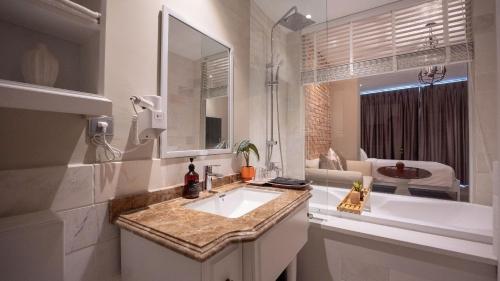 a white bathroom with a sink and a living room at Celine Living - Central in Ho Chi Minh City