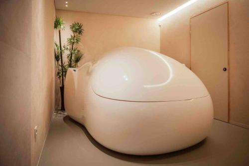 a large white pod in a room with a door at ChienMarin Healthfarm & Residences Anno 1712 ***** in Nieuwpoort