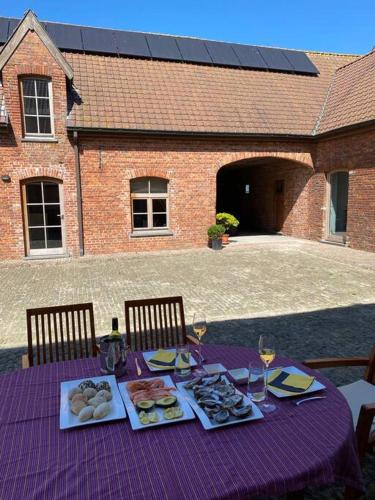 a purple table with plates of food on it at ChienMarin Healthfarm & Residences Anno 1712 ***** in Nieuwpoort
