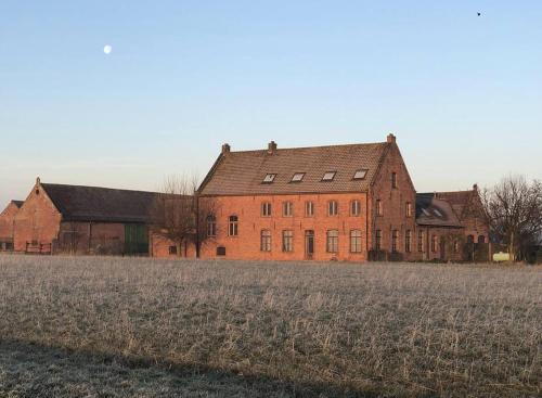 a large red brick building in a field at ChienMarin Healthfarm & Residences Anno 1712 ***** in Nieuwpoort