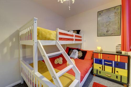 a childs bedroom with a bunk bed and a desk at Harry's House (Muggles welcome too!) in Watford