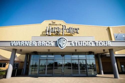 a sign on the front of a building at Harry's House (Muggles welcome too!) in Watford