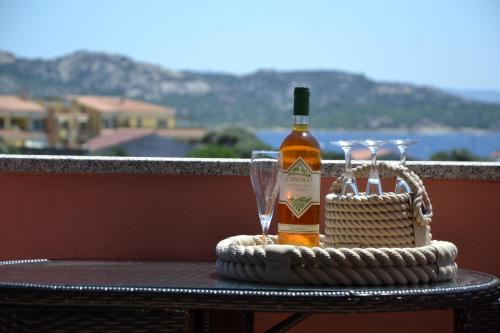 a bottle of wine and a glass on a table at Hotel Villa Del Parco in La Maddalena