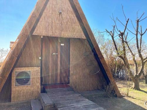 a large wooden building with a thatched roof at Casone Maranghetto in Marango di Caorle