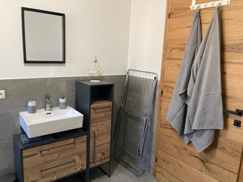a bathroom with a sink and a mirror at Ferienwohnung Jasmin in Wenns