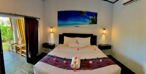 a bedroom with a large bed in a room at Edelweiss Homestay in Kuta Lombok