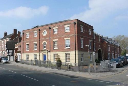 a large brick building on the side of a street at Cheshire Cat in Nantwich