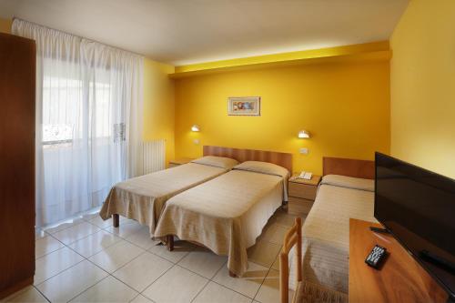Postel nebo postele na pokoji v ubytování Hotel La Querceta