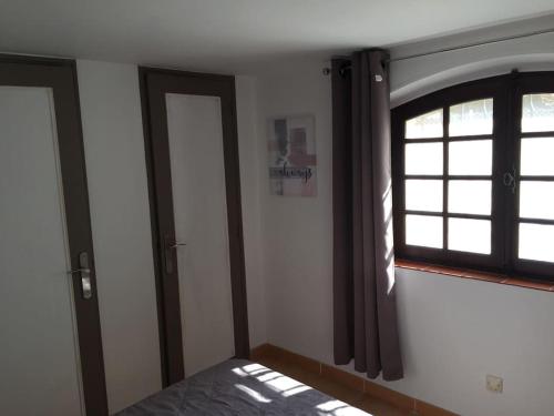 a bedroom with a window and a bed in it at Bandol T3 RDJ Plage 5 mn à pied-Port 10 Mn-Parking in Bandol