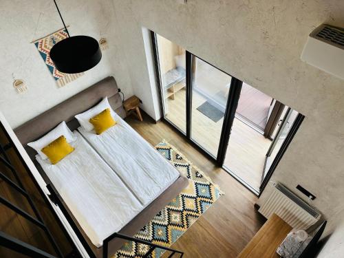 an overhead view of a bedroom with a bed and yellow pillows at Chalet CrepDeChine Hotel in Bukovel