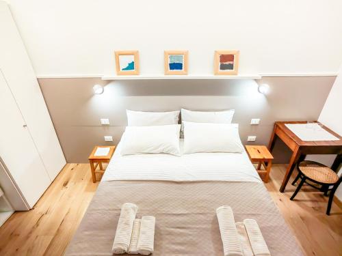a bedroom with a large bed with two tables at Home Dren in Prepotto