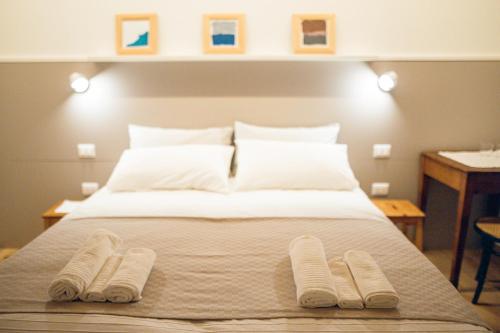 a bedroom with a bed with two towels on it at Home Dren in Prepotto