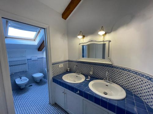a bathroom with a sink and a toilet and a mirror at The Secret Garden Relais in Piano di Sorrento