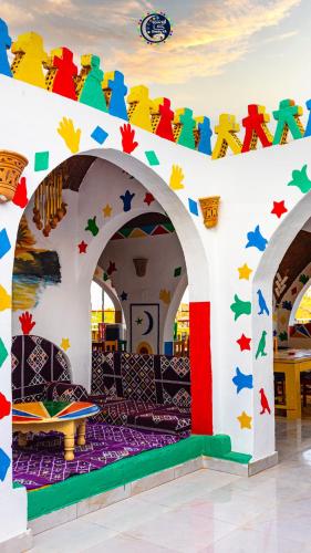 a room with colorful decorations on the wall at Onaty Ka Guest House in Aswan