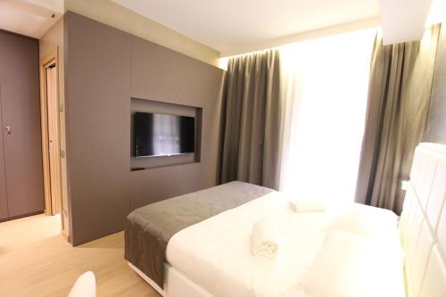 Ένα ή περισσότερα κρεβάτια σε δωμάτιο στο Mokinba Hotels Baviera