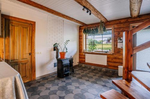 a room with a stove and a window in a house at Brīvdienu māja ''Rātes'' Valmiermuiža in Valmiermuiža