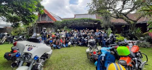 a group of people posing for a picture next to motorcycles at HOMESTAY ARGOPENI in Kalianget