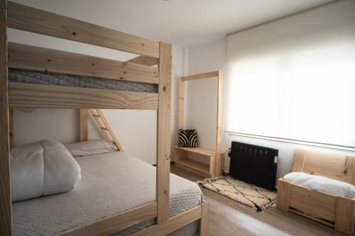 a bedroom with two bunk beds and a mirror at EDELWEISS HOUSE - Parking y Wifi GRATIS in Sierra Nevada