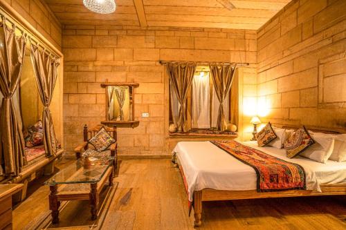 a bedroom with a bed and a table in a room at Hotel The Silk Route in Jaisalmer