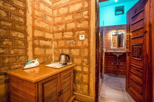 a bathroom with a counter and a sink in a room at Hotel The Silk Route in Jaisalmer