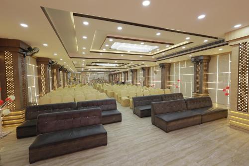 a large room with leather couches and chairs at THE BODHI PALACE RESORT in Bodh Gaya