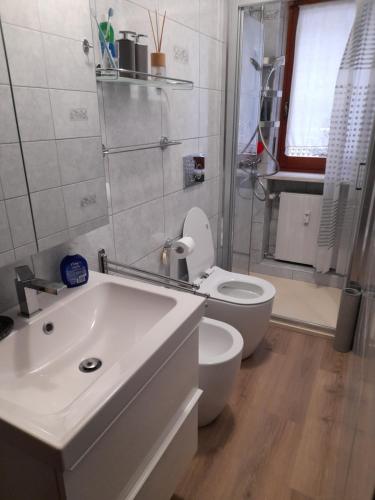 a bathroom with a white sink and a toilet at Einaudi 9 in Bardonecchia