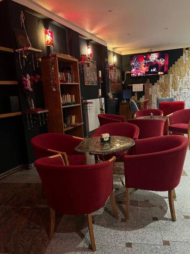 a restaurant with red chairs and a table in a room at Gallery Hotel SIS in Prague