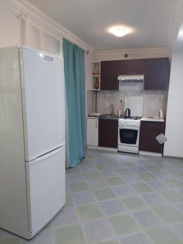 a kitchen with a white refrigerator and appliances at H&L Coworking and Live in Jrvezh