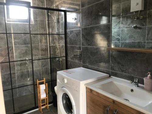 a bathroom with a washing machine and a sink at Tanem Suit in Kemer