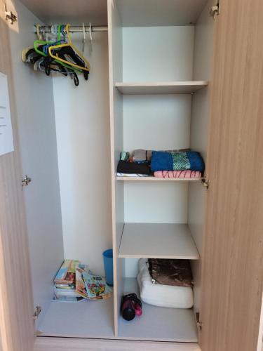 a room with a closet with shelves and a bed at Gites "les colibris" in Schœlcher