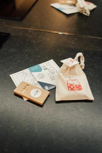 a table with a bag and some cards on it at Appartement Pixel by ExplorHome in Tignes