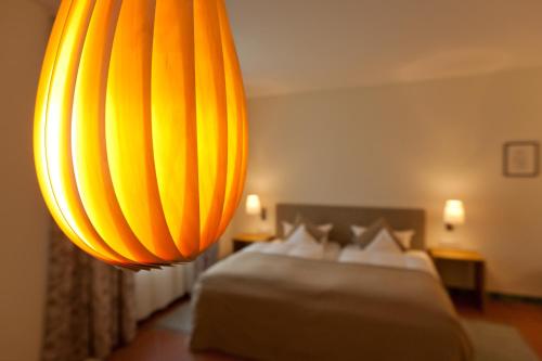a hotel room with a bed and a chandelier at Hotel Deutscher Hof in Trier