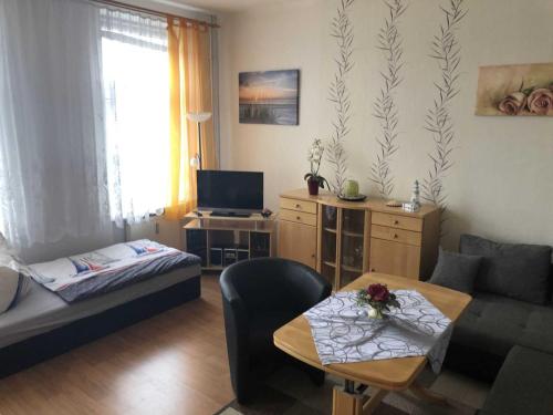 a living room with a couch and a table at Ferienwohnung Sprenger _ Objekt 25 in Rostock