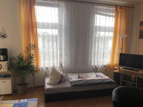 a room with a bed with two pillows on it at Ferienwohnung Sprenger _ Objekt 25 in Rostock