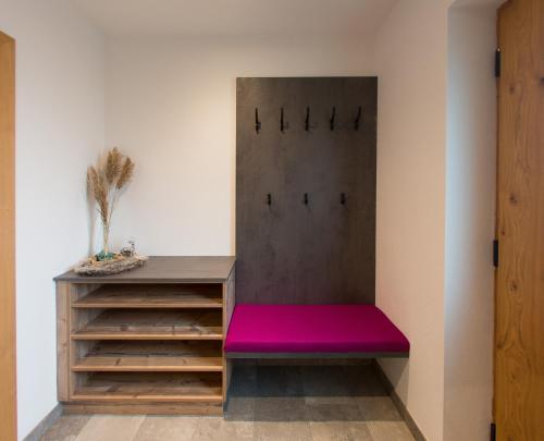 a room with a bench with a pink seat at Bio Schartenhof in Sankt Johann im Pongau