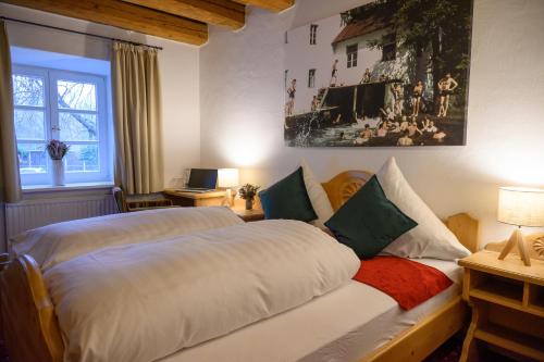 a bedroom with two beds and a window at InselMühle in Munich