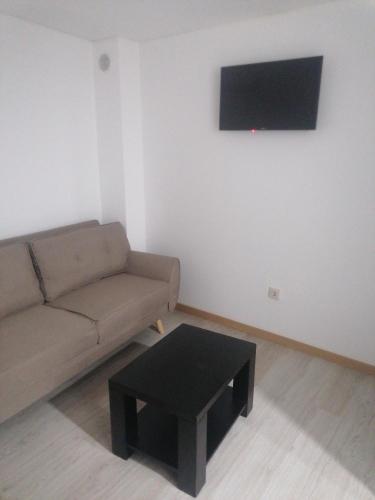 a living room with a couch and a coffee table at Casa do Castelo I in Bragança