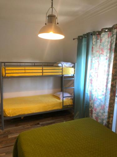 a room with two bunk beds and a light at Alojamento Mercado Sul in Lisbon