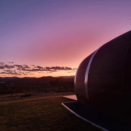 a view of the side of a building at sunset at Barrel View Luxury Cabins in Ballandean