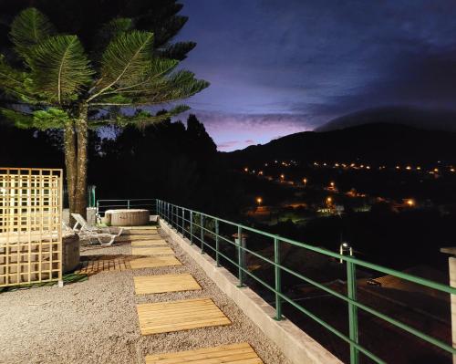 a stairway with a tree and a fence at night at Sleep and Go in Santana in Nature B&B in Santana