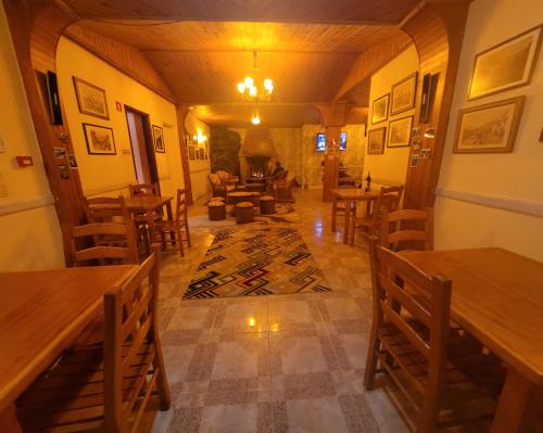 a living room with wooden tables and chairs at Sleep and Go in Santana in Nature B&B in Santana