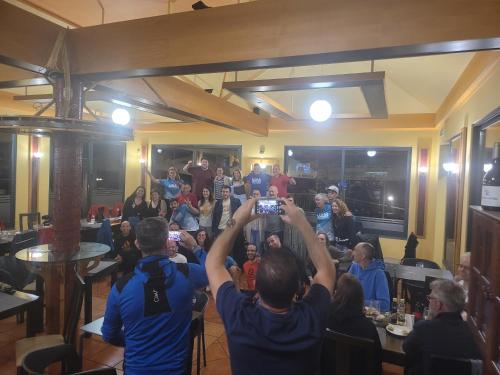 a person taking a picture of a crowd of people at Sleep and Go in Santana in Nature B&B in Santana