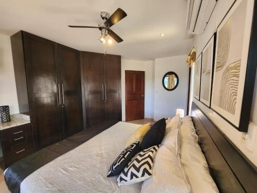 a bedroom with a bed and a ceiling fan at Amazing Oceanview rooftop terrace walk to beach in Coco