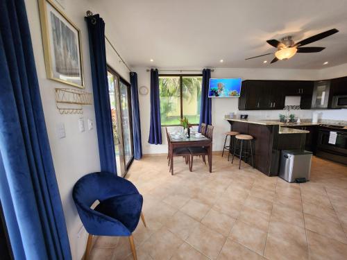 a kitchen and dining room with a table and a blue chair at Amazing Oceanview rooftop terrace walk to beach in Coco